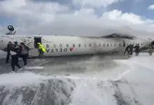 "Image of Delta Flight 4819 overturned on the runway at Toronto Pearson Airport, with emergency crews responding to the crash scene."